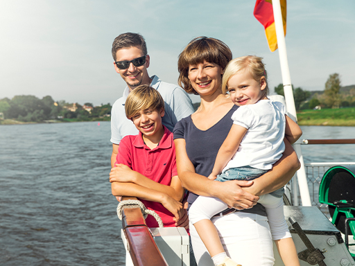 Ein Familienportrait bei schönem Wetter an Deck eines Dampfers.