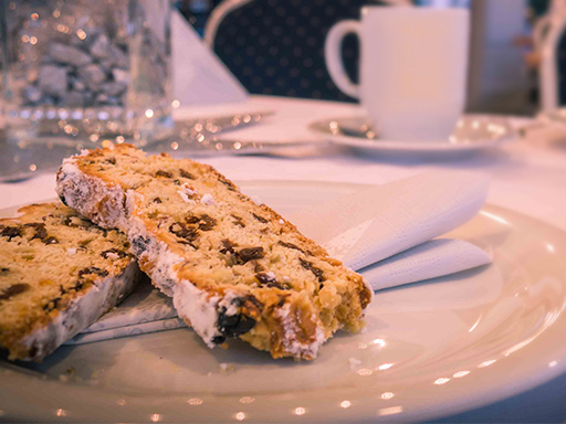 Zwei Stücke Stollen liegen auf einem weißen Teller.