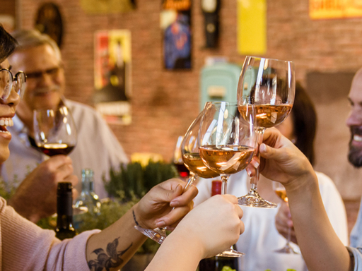 Several people clink their wine glasses,